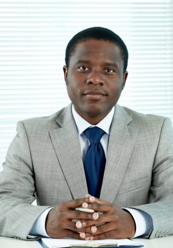 Portrait of confident African businessman looking at camera in office